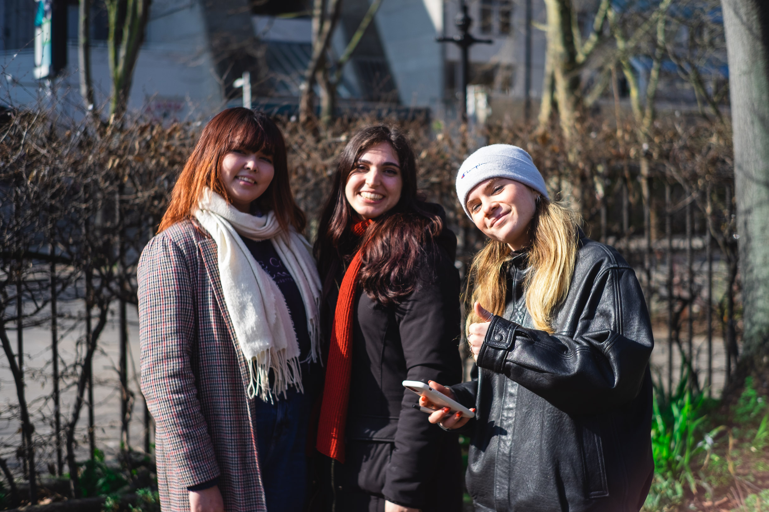Three friends posing together outdoors
