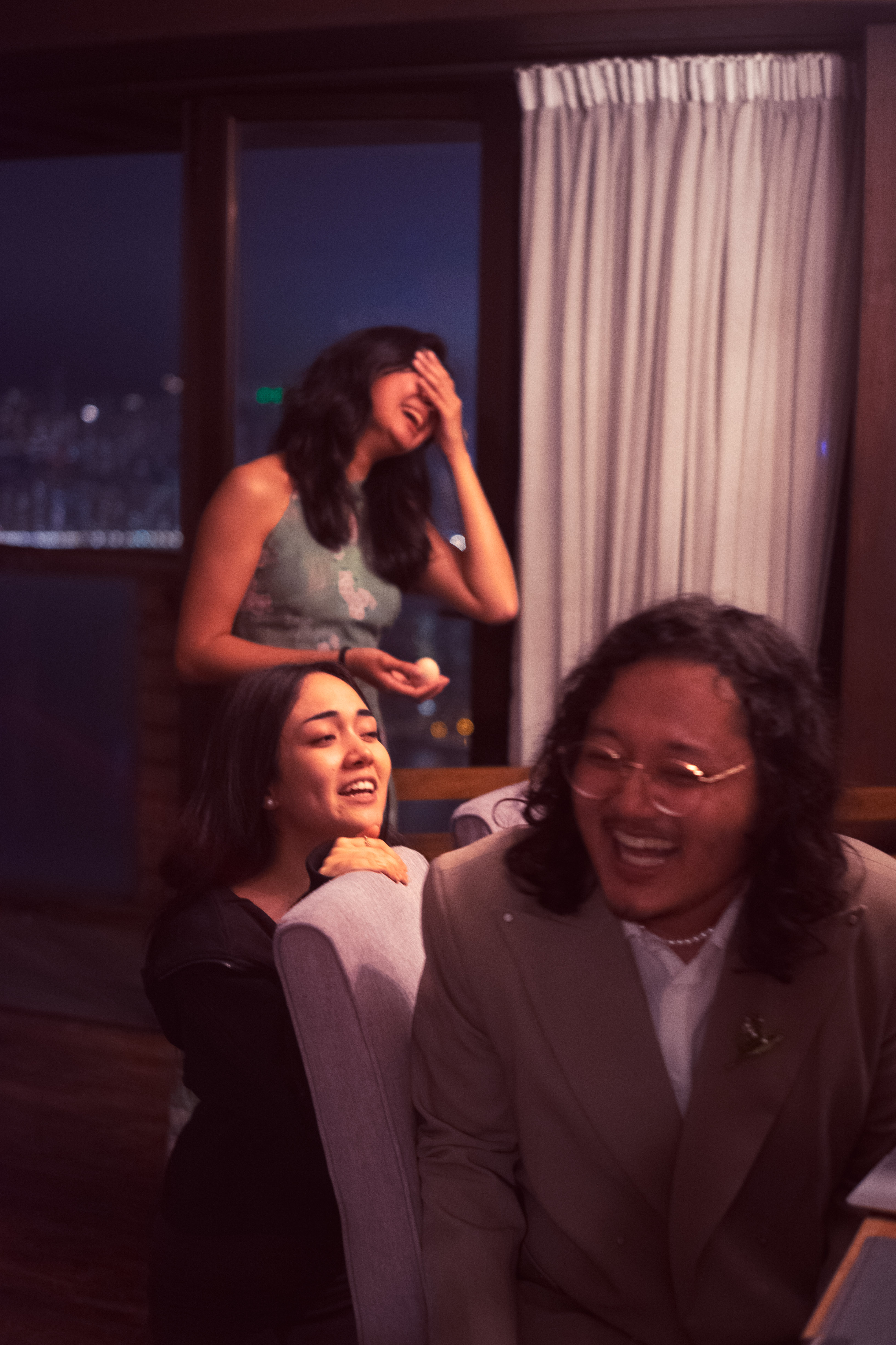 Friends laughing on a sofa